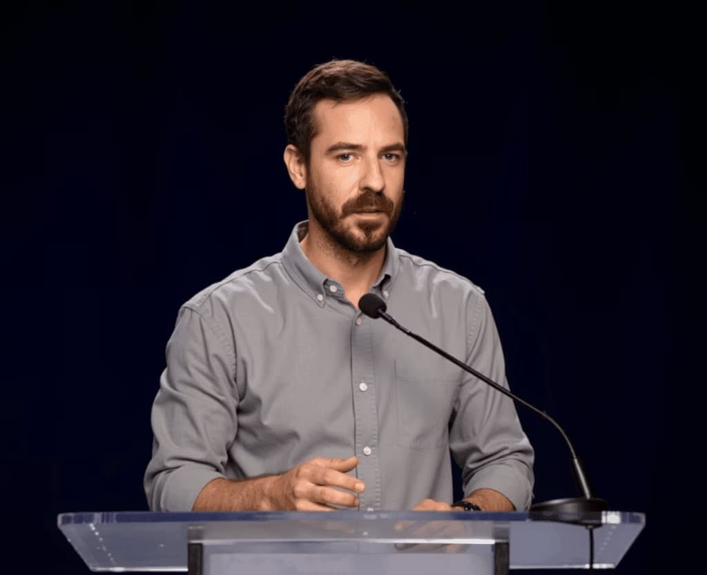 Jack Price speaking at a lectern